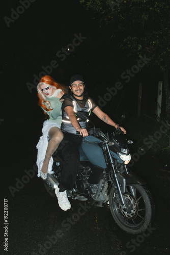 Drag queen on motorcycle with smiling man 