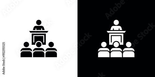 Black and white of speaker at podium with audience 2