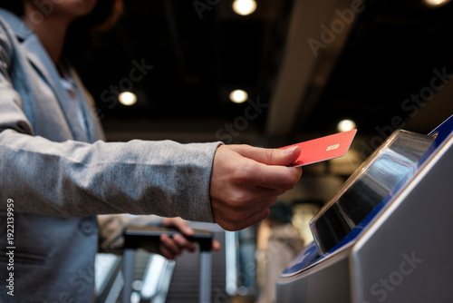 Photography Traveler scanning contactless payment card for airport boarding