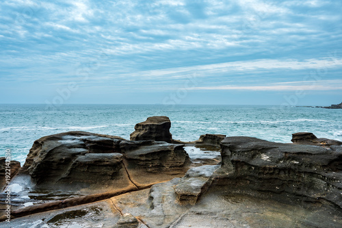Sea Cliff Bridge coastal bridge and ocean views with seaside restaurant, street scene and colorful parrots along the Pacific coast, New South Wales, Australia editorial travel landscape