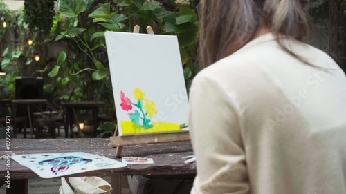 Authentic Gen Z happy young adult asian woman painting brush on canvas at workshop cafe creativity lifestyle therapy