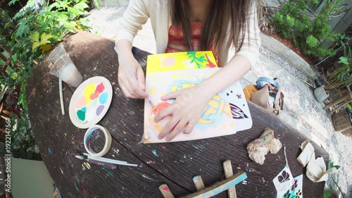 Authentic Gen Z happy young adult asian woman painting brush on canvas at workshop cafe creativity lifestyle therapy