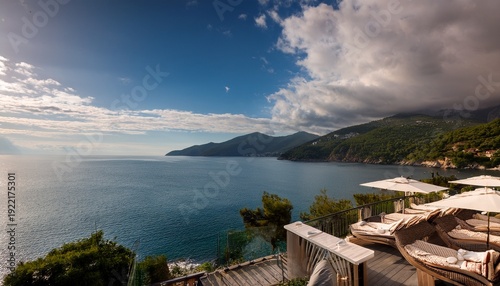 Relax By The Sea At A Resort With Hills And Water Under A Cloudy Sky In An Outdoor Setting