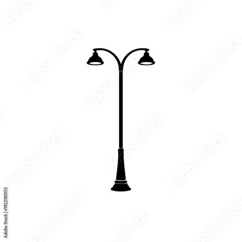 A tall street lamp with three lights, two at the top and one at the base.