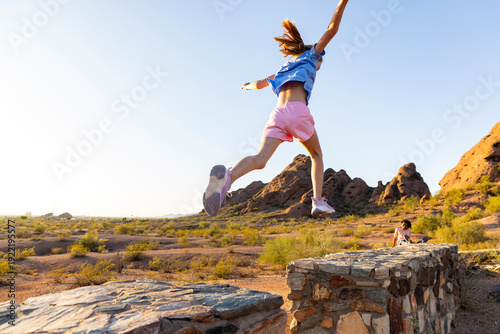 Young Girl Jump hike rear view 