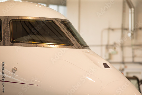 Reflections in aircraft windows revealing cockpit instruments and features. Inside view highlighting reflections on cockpit windows along with control panels and viewing features
