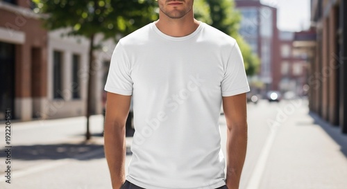 Man Wearing White T-Shirt on City Street.
