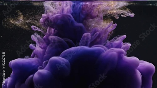 Abstract purple and magenta ink swirling in water