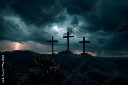 Conceptual image of Good Friday, three wooden crosses standing on a dark hilltop under a heavy stormy sky