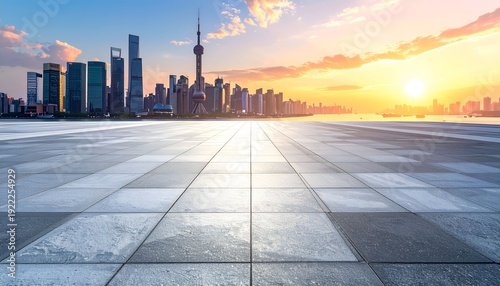 City skyline at sunrise, with a tiled foreground reflecting the warm, golden light