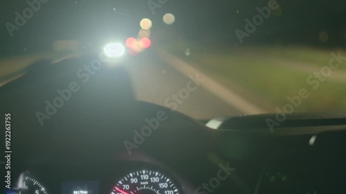 driver steering wheel night road ahead with blurred taillights, dashboard glow and bokeh lights, latenight commute atmosphere, focused hands on wheel, cinematic motion and lowlight tension