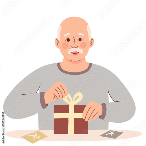 Elderly man unwrapping a gift with a smile at a table indoors. Elderly set