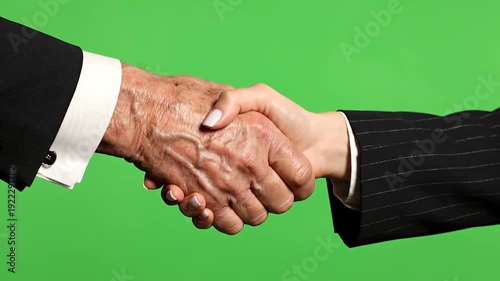 Close Up of Young and Old Hands Shaking Firmly on Green Screen