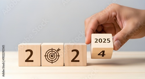 A person flipping wooden blocks to change the year from 2024 to 2025