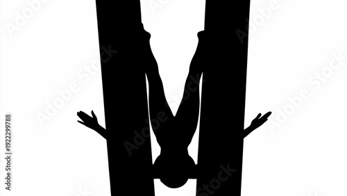 Man doing handstand between two large letters