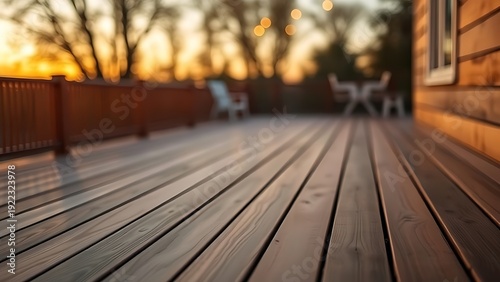Wooden deck bathed in warm dusk light, creating a serene outdoor atmosphere with softly blurred surroundings. travel magazines.