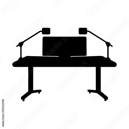 Studio Desk with Computer Monitor and Microphones in Silhouette