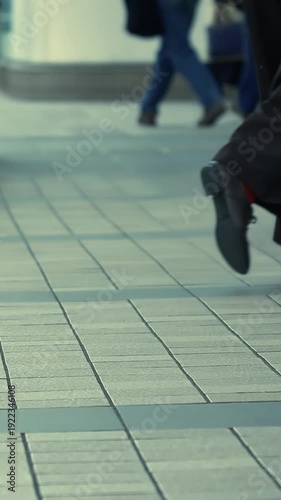 Low angle shot of business shoes walking on a clean city pavement in Tokyo.