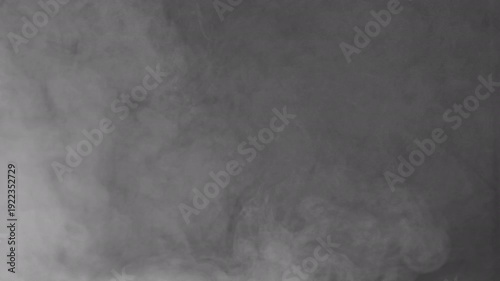 Gray Mist on Dark Backdrop. Vapor emerging from shadows, forming transient shapes before dissolving into obscurity with gradual shifts.