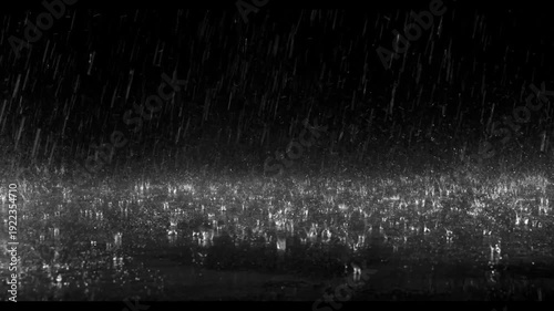 Realistic rain drops hitting the ground creating beautiful water splashes on a dark black background. Perfect cinematic rain overlay for video editing, visual effects, films, trailers, music videos