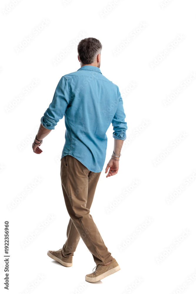 Fototapeta premium Casual young man walking and looking away