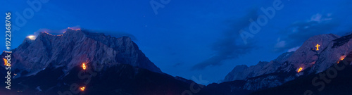 Obraz na plátně Mountain peaks illuminated by traditional solstice fires in the Austrian Alps at