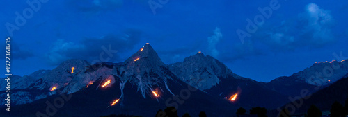 Obraz na plátně Mountain peaks illuminated by traditional solstice fires in the Austrian Alps at