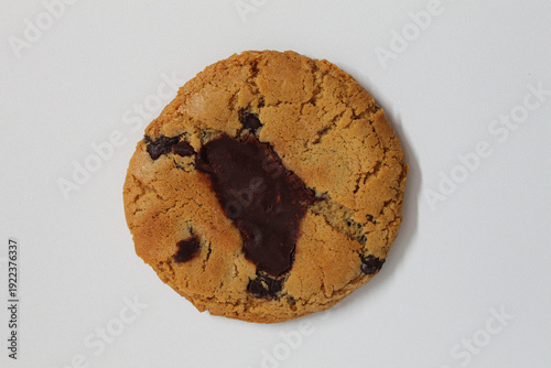 One chocolate soft cookie, melted chocolate, isolated on white background