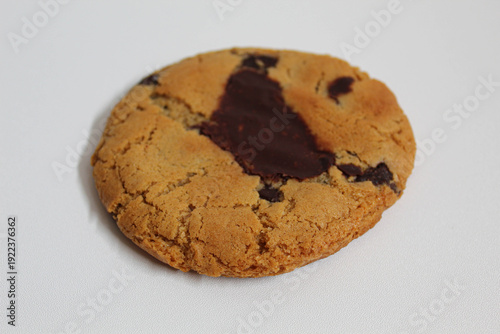 One chocolate soft cookie, melted chocolate, isolated on white background