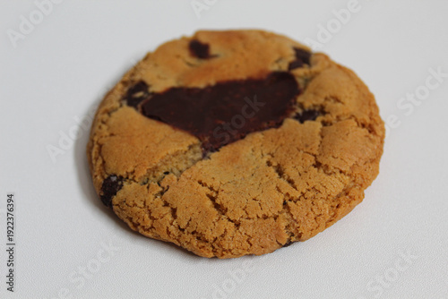 One chocolate soft cookie, melted chocolate, isolated on white background