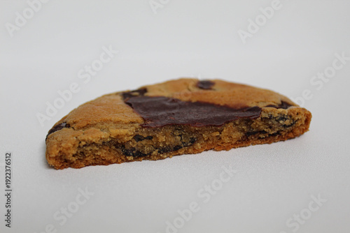 One chocolate soft cookie, melted chocolate, isolated on white background