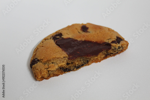 One chocolate soft cookie, melted chocolate, isolated on white background