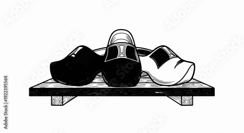 Three wooden clogs, black, white, and patterned, sit on a wooden plank