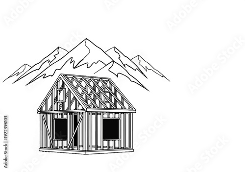 Unfinished wooden house framed in front of rugged mountain range outline