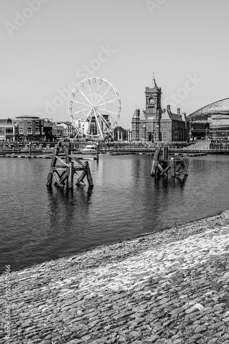Cardiff, Wales:  Pierhead Building and ferris wheel at Cardiff bay on  the river mouth of River Taff and River Ely in black and white