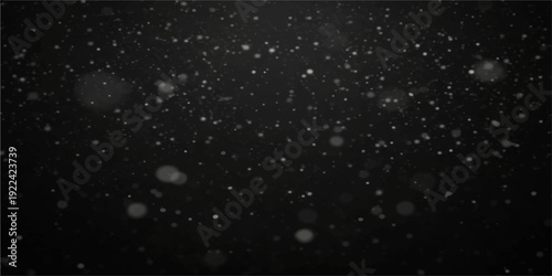 A dark winter night sky filled with falling snowflakes and rain drops amidst abstract glowing star particles and galaxy dust for a Christmas celebration