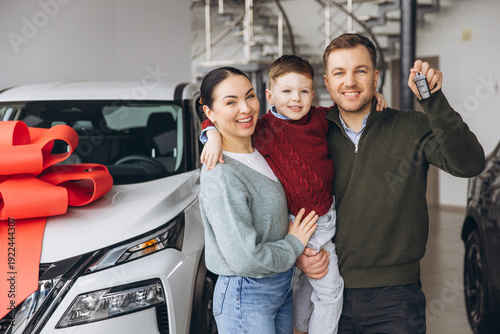 Φωτογραφία Happy family buying new car, receiving keys, celebrating vehicle ownership and p