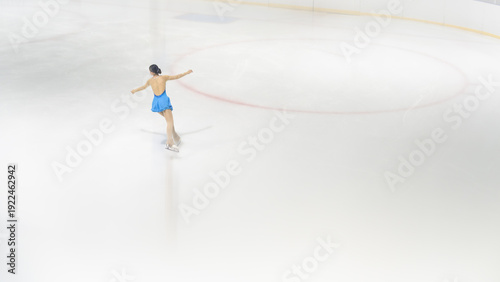 Elegant Ice Skater Gliding Gracefully on Smooth Ice Rink Surface