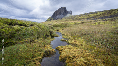 Icelandic landscape with rhinoceros like mountain and river streaming towards it, Highlands, Iceland