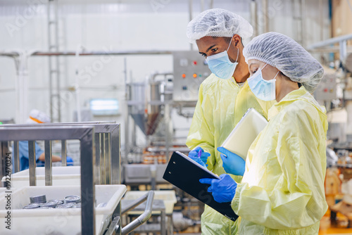 Φωτογραφία Food hygiene inspector team work examination food production process in line at