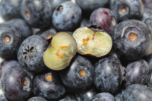 Cross section blueberry among the whole fruits, isolated on white background