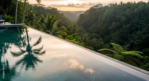 A modern minimalist infinity pool at a luxury Balinese resort reflects a golden sunset over a lush jungle valley.