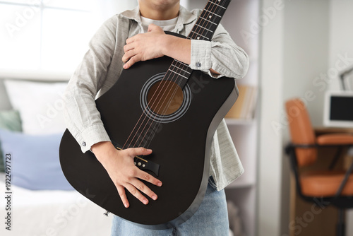 Cute boy with guitar in bed...
