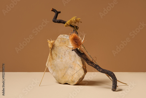 Dried flowers, twig and sto...
