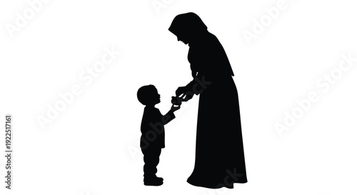 Mother and child share a tender moment in striking silhouette