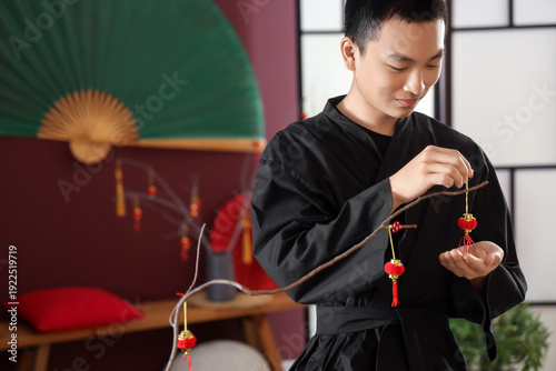 Young Asian man decorating ...