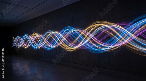 Dynamic light trails featuring blue, purple, and yellow double helix patterns illuminating a dark, minimalist concrete interior, symbolizing data, science, and energy