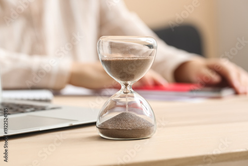 Hourglass with laptop near ...