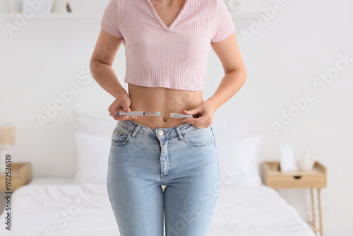 Woman with syringe of IVF h...