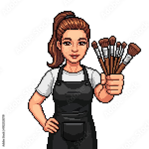 Woman holding a set of makeup brushes, wearing an apron and t-shirt.